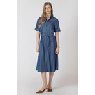 Woman wearing a blue denim dress on a white background