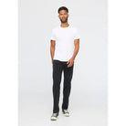 Man wearing a white t-shirt and black jeans on a white background